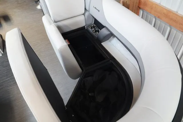 Slide: The Image of 2025 Lowe SS 230 WV boat interior with white seating and storage compartment. - 13