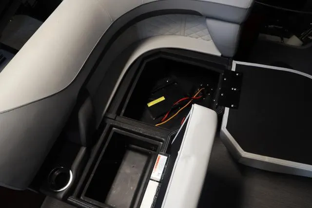 Slide: The Image of 2025 Lowe SS 230 WV boat interior storage compartment with wiring and cup holder. - 17