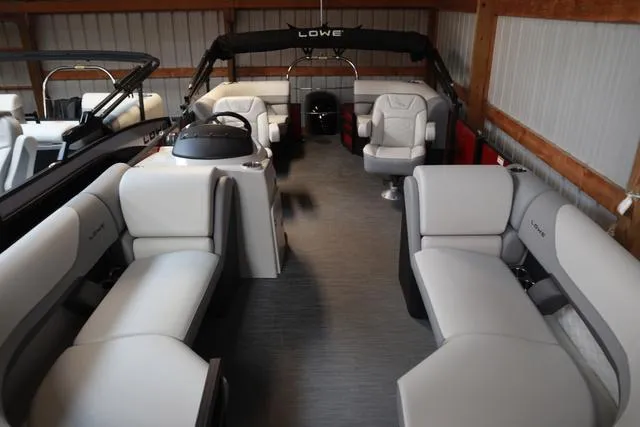 Slide: The Image of 2025 Lowe SS 230 WV Special Triple Tube pontoon boat interior with plush seating and modern design. - 19