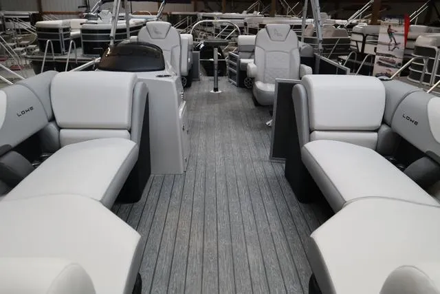 Slide: The Image of 2025 Lowe SS 230 WT Triple Tube pontoon boat interior with plush seating. - 6