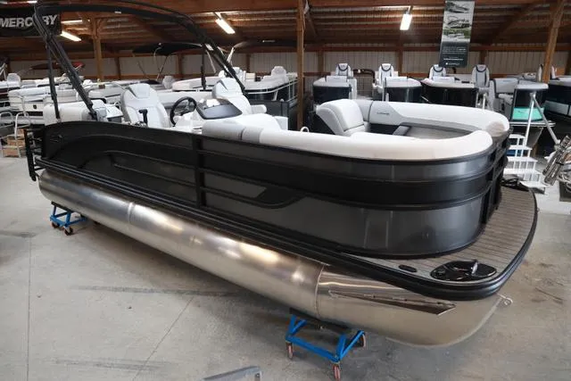 Slide: The Image of 2025 Lowe SS 230 WT Triple Tube pontoon boat in showroom, featuring sleek design and spacious seating. - 7
