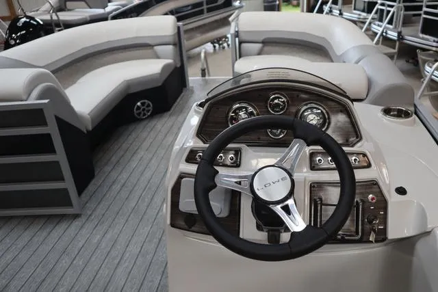 Slide: The Image of 2025 Lowe SS 230 WT Triple Tube Package boat interior with steering wheel and seating. - 9