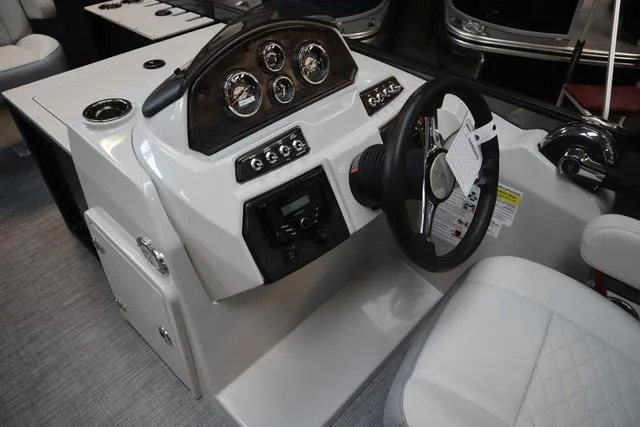 Slide: The Image of 2025 Lowe SF 212 WT Triple Tube Pkg boat dashboard with steering wheel and controls. - 6