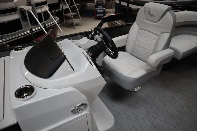 Slide: The Image of 2025 Lowe SF 212 WT Triple Tube Pkg boat interior with steering console and cushioned seat. - 7