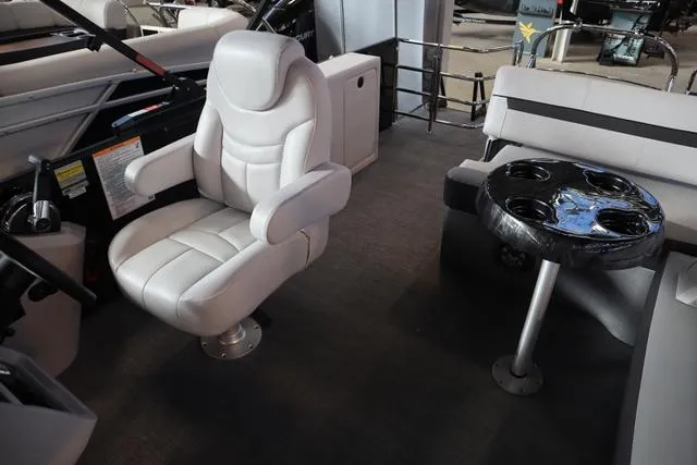 Slide: The Image of 2024 Godfrey Sweetwater 2286 SFL boat interior with captain's chair and table. - 10