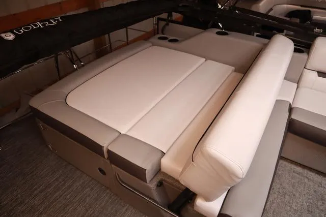 Slide: The Image of 2024 Godfrey Sweetwater 2286 SFL boat interior with plush seating and cup holders. - 12