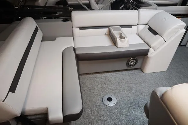 Slide: The Image of 2024 Godfrey Sweetwater 2286 SFL boat interior with plush seating and cup holders. - 8