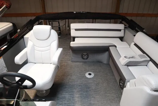 Slide: The Image of 2024 Godfrey Sweetwater 2286 SFL Triple Tube Package interior with white seating and steering. - 9