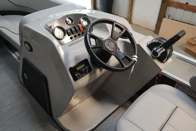 Slide: The Image of 2023 Lowe Ultra Cruise 160 boat dashboard with steering wheel and control panel. - 4
