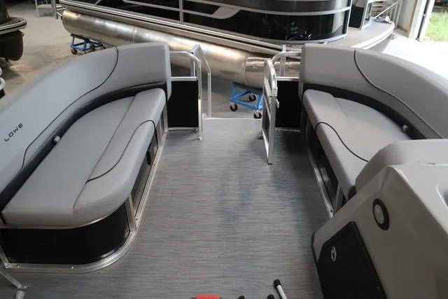 Slide: The Image of 2023 Lowe Ultra Cruise 160 pontoon boat interior with gray seating and open deck layout. - 5