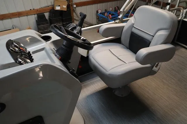 Slide: The Image of 2023 Lowe Ultra Cruise 160 boat interior with steering wheel and captain's chair. - 7