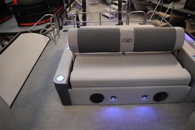 Slide: The Image of 2025 Bentley Pontoons Elite 253 Swingback interior with cushioned seating and ambient lighting. - 10