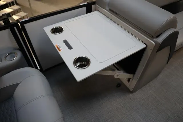 Slide: The Image of 2025 Bentley Pontoons Elite 253 Swingback interior with foldable table and cup holders. - 26