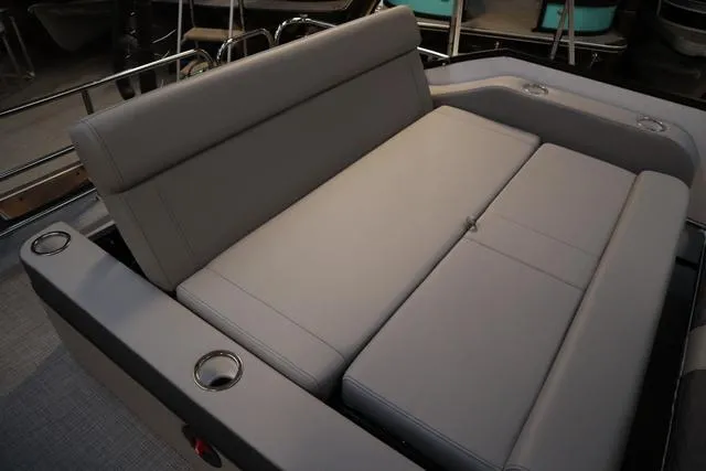 Slide: The Image of 2025 Bentley Pontoons Elite 253 Swingback seating area with gray upholstery and cup holders. - 34