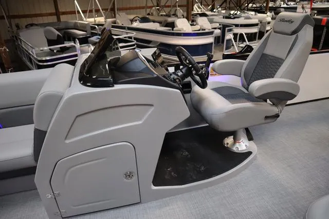 Slide: The Image of 2025 Bentley Pontoons Elite 253 Swingback helm with luxurious seating and modern controls. - 4