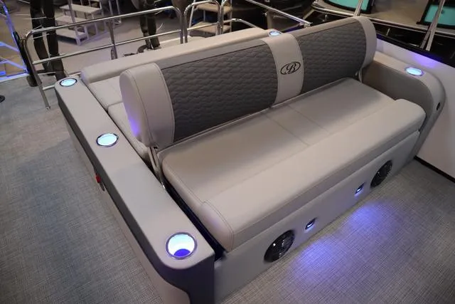 Slide: The Image of 2025 Bentley Pontoons Elite 253 Swingback interior with luxurious seating and ambient lighting. - 5