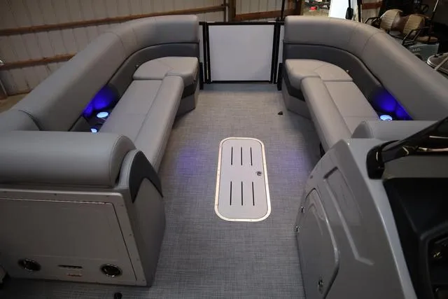 Slide: The Image of 2025 Bentley Pontoons Elite 253 interior with gray seating and ambient lighting. - 6