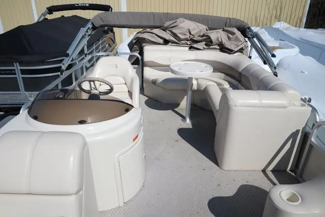 Slide: The Image of 2006 Bennington GL 2050 boat interior with beige seating and steering console. - 4