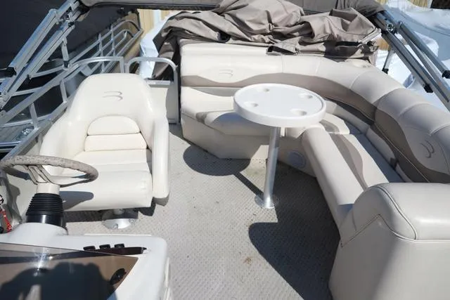 Slide: The Image of 2006 Bennington GL 2050 boat interior with beige seating and round table. - 7