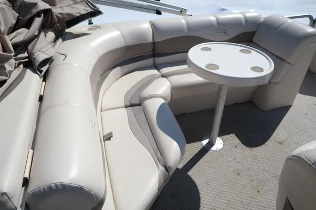 Slide: The Image of 2006 Bennington GL 2050 boat interior with beige seating and round table. - 9