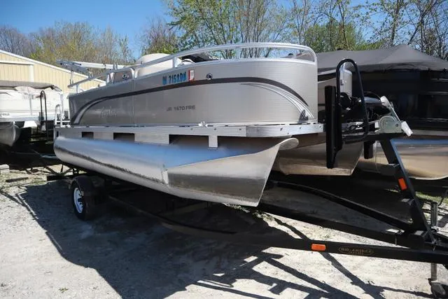 Slide: The Image of 2013 Avalon 1670 Fish pontoon boat on trailer, parked outdoors. - 8