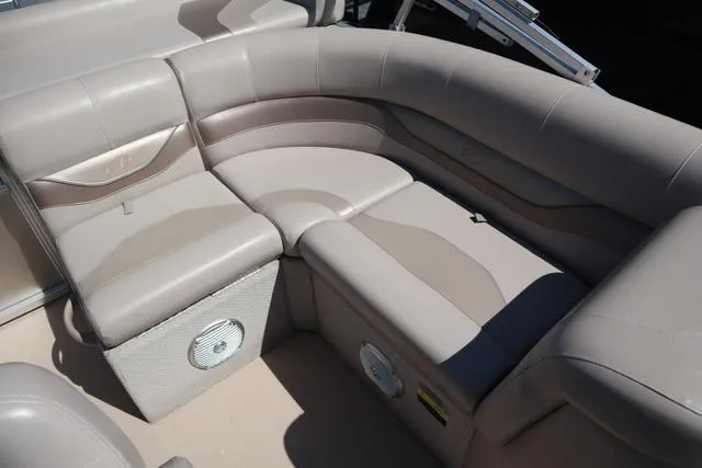 Slide: The Image of 2013 Avalon 1670 Fish boat interior with beige cushioned seating. - 9