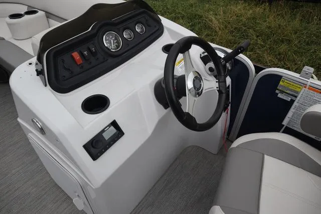 Slide: The Image of 2022 Sweetwater 2286SBX boat dashboard with steering wheel and control panel. - 3