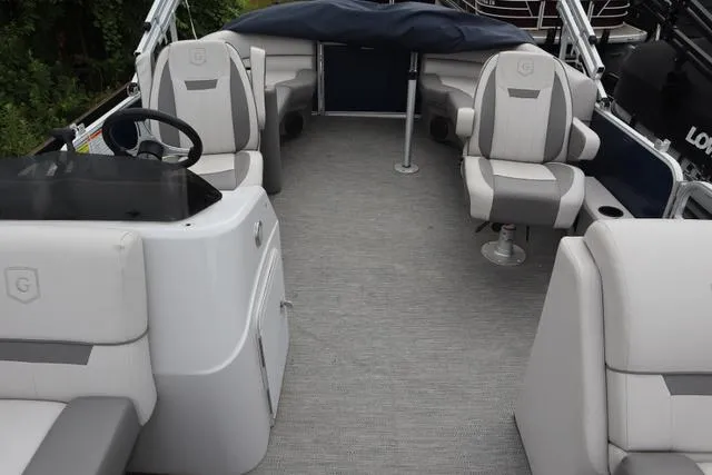 Slide: The Image of 2022 Sweetwater 2286SBX boat interior with gray seating and steering console. - 7