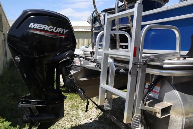 Slide: The Image of 2020 Lowe SF 214 boat with Mercury outboard motor and ladder, parked outdoors. - 4