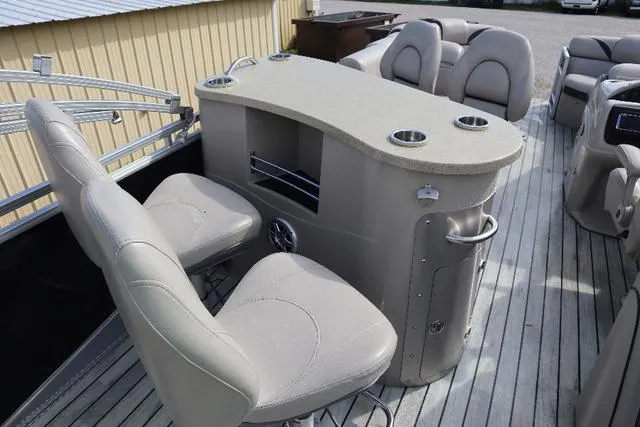 Slide: The Image of 2017 Berkshire 23 E STS boat interior with seating and bar area. - 3
