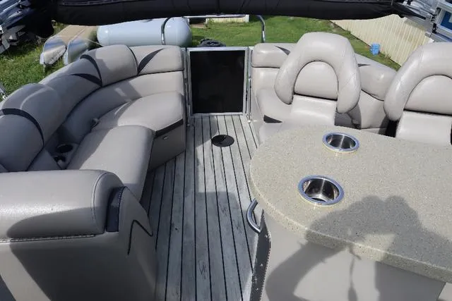 Slide: The Image of 2017 Berkshire 23 E STS pontoon boat interior with plush seating and table. - 9