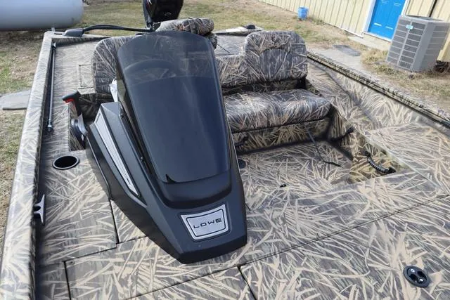 Slide: The Image of 2024 Lowe Stinger 175 Poly Camo boat with camouflage seating and console. - 3