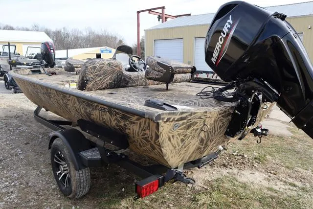 Slide: The Image of 2024 Lowe Stinger 175 Poly Camo boat with Mercury engine, parked outdoors. - 4