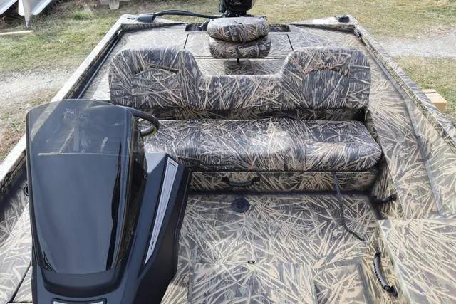 Slide: The Image of 2024 Lowe Stinger 175 Poly Camo boat interior with camouflage seating and console. - 9