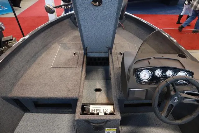 Slide: The Image of 2025 Crestliner 1750 HAWK SC JS boat interior with steering console and storage compartments. - 9