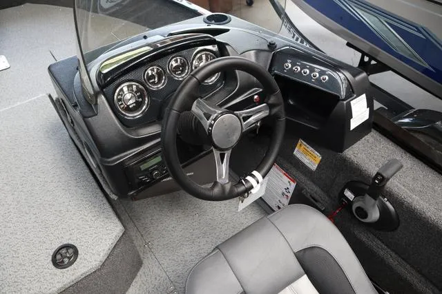 Slide: The Image of 2024 Lowe FM 1775 SC boat dashboard with steering wheel and control panel. - 5