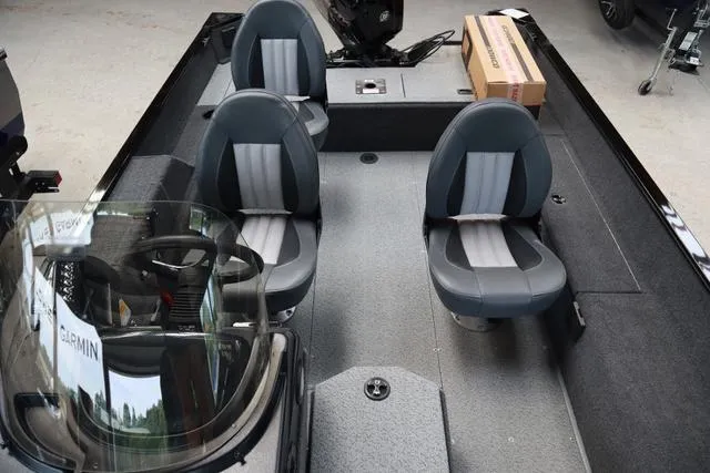 Slide: The Image of 2024 Lowe FM 1775 SC boat interior with four seats and a steering console. - 9