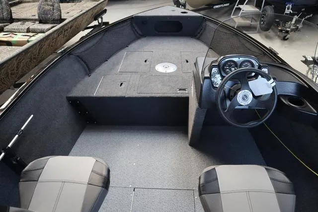 Slide: The Image of 2025 Crestliner 1650 Kodiak SC boat interior with steering console and seating. - 8