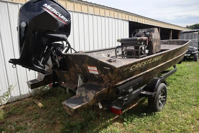 Slide: The Image of 2024 Crestliner 1870 Retriever FCC Tunnel boat with Mercury engine, camo design, on trailer. - 2