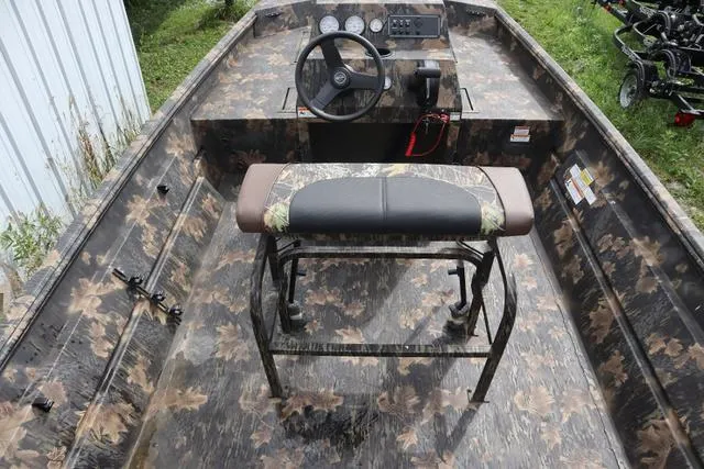 Slide: The Image of 2024 Crestliner 1870 Retriever FCC Tunnel boat interior with camouflage design and steering console. - 4