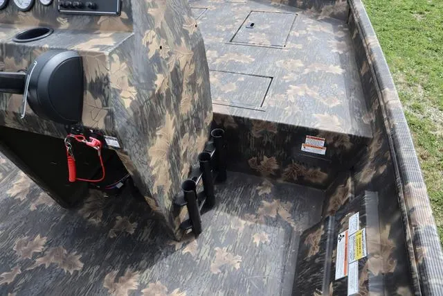 Slide: The Image of 2024 Crestliner 1870 Retriever FCC Tunnel boat interior with camouflage design and rod holders. - 5