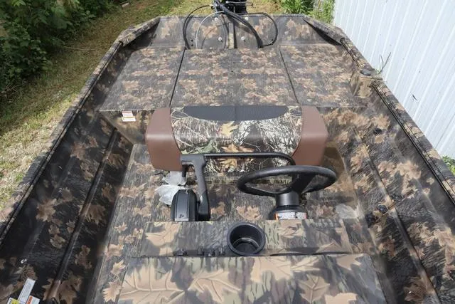 Slide: The Image of 2024 Crestliner 1870 Retriever FCC Tunnel boat with camouflage design and steering console. - 8