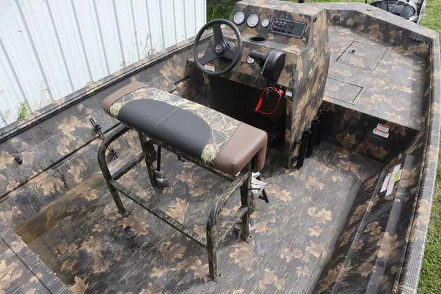 Slide: The Image of 2024 Crestliner 1870 Retriever FCC Tunnel boat with camo design and steering console. - 9