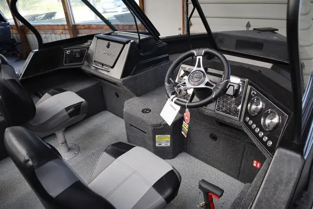 Slide: The Image of 2025 Crestliner 1850 Fish Hawk WT JS boat interior with steering wheel and seating. - 3