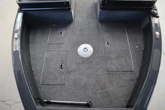 Slide: The Image of 2025 Crestliner 1850 Fish Hawk WT JS boat interior with carpeted deck and storage compartments. - 7