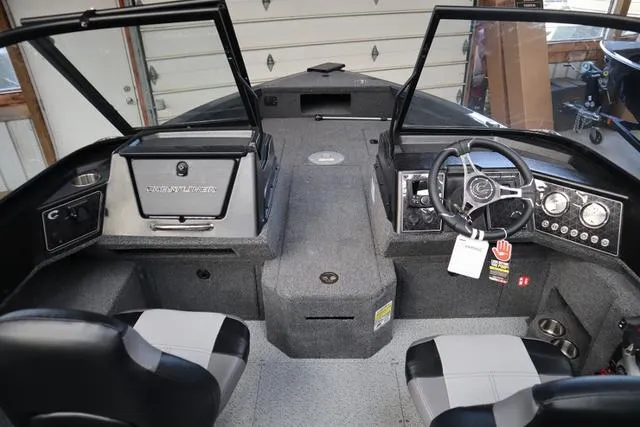 Slide: The Image of 2025 Crestliner 1850 Fish Hawk WT JS boat interior with dual seats and steering console. - 9