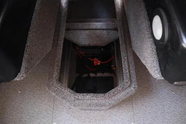 Slide: The Image of 2025 Lowe FM 1775 WT boat storage compartment with visible wiring. - 13