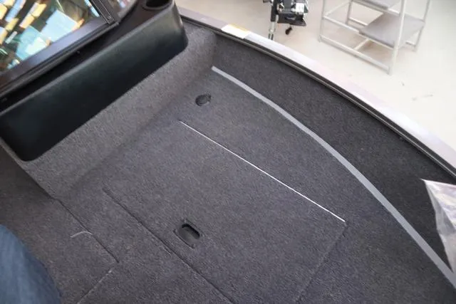 Slide: The Image of 2025 Lowe FM 1775 WT boat interior with carpeted flooring and storage compartment. - 15