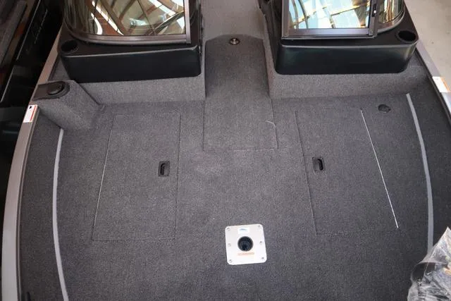 Slide: The Image of 2025 Lowe FM 1775 WT boat interior with carpeted deck and storage compartments. - 20