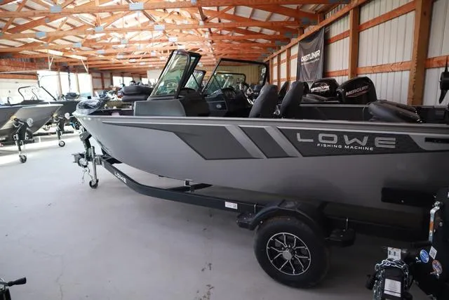 Slide: The Image of 2025 Lowe FM 1775 WT fishing boat in a showroom, featuring sleek design and modern features. - 21